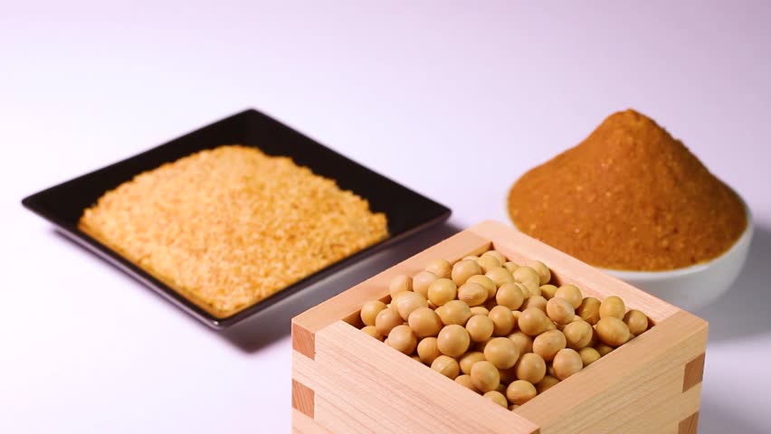 Miso, soybeans and miso powder on white background, rotating