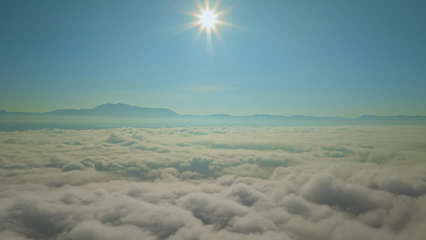 A breathtaking view of mist-covered mountains bathed in morning sunlight, with dramatic rays streaming through the clouds, creating a tranquil and atmospheric scene.