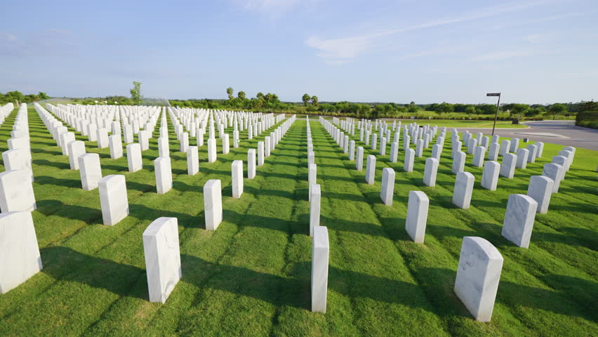 Sarasota National Cemetery with many white headstones on green grass lawn. Memorial Day concept.