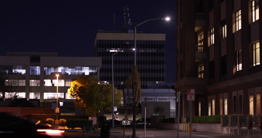 Evening traffic streams by the downtown skyline buildings of Bakersfield, California, USA.