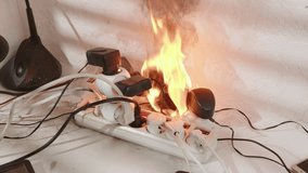 Power cube strip on fire with electrical plugs in sockets burns with open flame and smokes indoor room. - Powered by Shutterstock - Get 15% off with code: PIKWIZARD15
