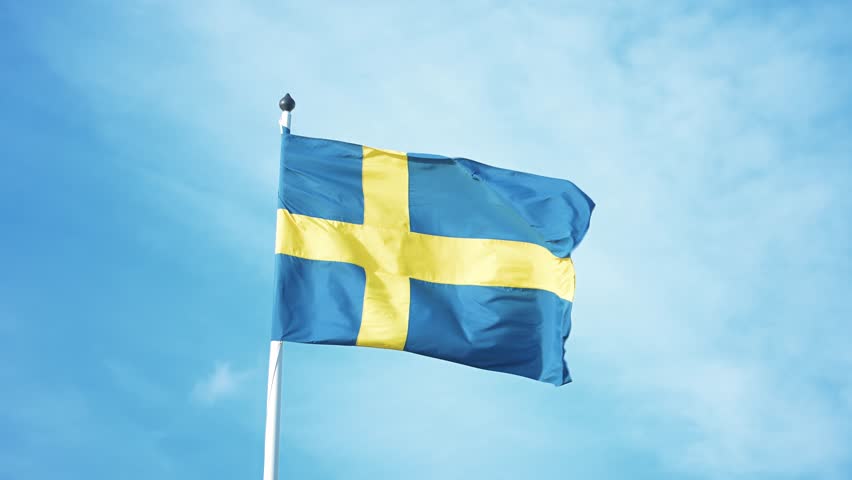 Swedish flags waving with the wind flow under the blue sky for national day celebration and symbol of european union. Swedish National day, midsummer, copyspace.