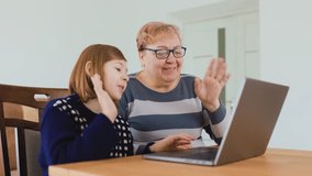 A grandmother and granddaughter share a joyful moment while connecting through a virtual call. Their smiles and laughter fill the room, showcasing the warmth of family bonds. - Powered by Shutterstock - Get 15% off with code: PIKWIZARD15
