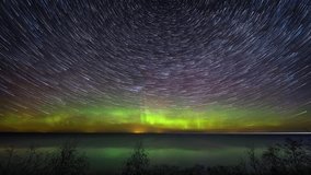 Scenic timelapse. Star trails with the northern lights above the scenic sea. - Powered by Shutterstock - Get 15% off with code: PIKWIZARD15