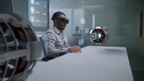 African American Engineer Uses Augmented Reality Headset to Visualize 3D Holographic Model of Renewable Energy Engine. Virtual Visualization of Design Software Based on Artificial Intelligence. - Powered by Shutterstock - Get 15% off with code: PIKWIZARD15