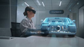 Futuristic Office: Female Automotive Professional Wearing Headset Uses Virtual Reality Hologram to Construct 3D Prototype of High-Tech Electric Car on Li-Ion Battery. Advanced Artificial Intelligence. - Powered by Shutterstock - Get 15% off with code: PIKWIZARD15