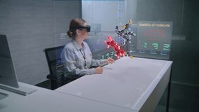 Female Professional Uses Augmented Reality Headset to Visualize 3D Hologram of Molecular Compounds in Advanced Office. Virtual Visualization of Artificial Intelligence Based Software Interface. - Powered by Shutterstock - Get 15% off with code: PIKWIZARD15