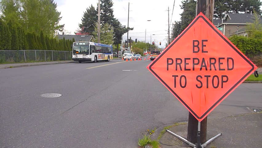 Road construction at intersection with city buses driving by and Be Prepared to