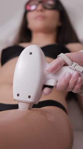 Professional laser hair removal in a beauty salon. Hair removal in the leg area. Vertical video