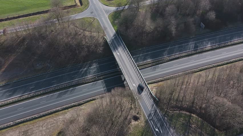 Highway traffic crossing under bridge