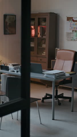 No people vertical shot of professional and organized office of school psychologist with desk, bookshelves and bulletin board