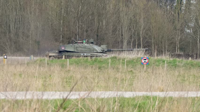 British army Challenger 2 II FV4034 main battle tank in action by woodland cover