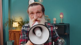 Senior bearded business man talking with megaphone announcing news loudly announcing advertising in home office. Elderly grandfather manager warns using loudspeaker and shouting speech looks at camera - Powered by Shutterstock - Get 15% off with code: PIKWIZARD15