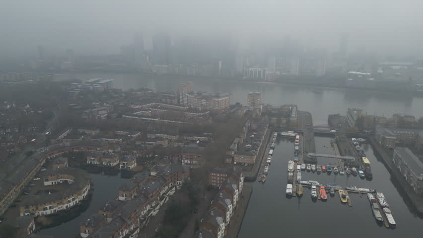 Aerial drone video of Thames Riverside in a fog.
