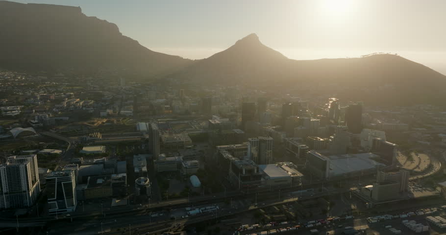 Establishing Aerial view of Cape Town Central Business Downtown District and Table Mountains in South Africa. Urban Cityscape of Capital city with Skyline and Landscape. 4K right panoramic drone shot