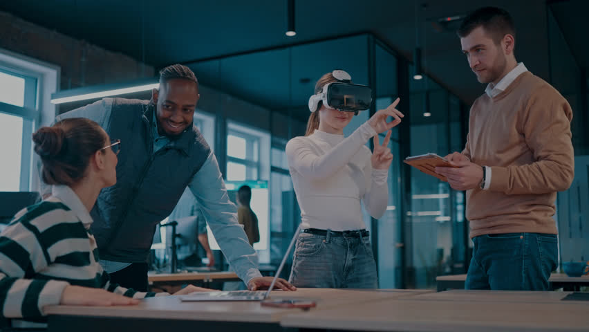 Disabled businesswoman in a wheelchair working in modern coworking office. Team around is using virtual reality goggles, collaborating with the latest technology in an open space startup creative - Powered by Shutterstock - Get 15% off with code: PIKWIZARD15