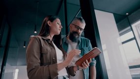 Creative millennials, casual business team, small business owners, working on social media strategy and brand development with a digital tablet in a modern, open space startup office - Powered by Shutterstock - Get 15% off with code: PIKWIZARD15