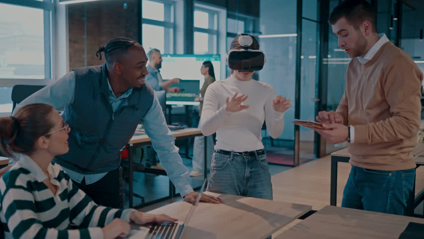 Disabled businesswoman in a wheelchair working in modern coworking office. Team around is using virtual reality goggles, collaborating with the latest technology in an open space startup creative - Powered by Shutterstock - Get 15% off with code: PIKWIZARD15