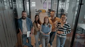 A diverse team of professionals in a modern coworking startup office smiles together, showcasing teamwork, collaboration, and a positive corporate culture that promotes innovation and a dynamic work - Powered by Shutterstock - Get 15% off with code: PIKWIZARD15