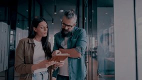 Creative millennials, casual business team, small business owners, working on social media strategy and brand development with a digital tablet in a modern, open space startup office - Powered by Shutterstock - Get 15% off with code: PIKWIZARD15