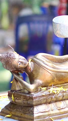 Sequential pouring of water over a religious statue