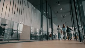 Business team in a modern open space startup office walking together. Diverse group of businesspeople smiling while having a discussion. Successful mixed race colleagues collaborating on a new project - Powered by Shutterstock - Get 15% off with code: PIKWIZARD15