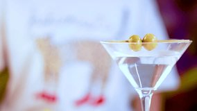 A vibrant display of cocktails including a martini with olives and a colorful drink with lime garnish in a lively setting - Powered by Shutterstock - Get 15% off with code: PIKWIZARD15