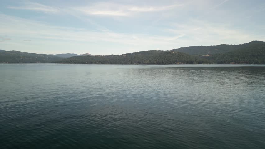 Low aerial above lake coeur dalene in northern Idaho on cloudy summer day