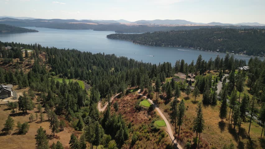 Aerial of golf course and luxury homes on Coeur Dalene lake in north Idaho in summer