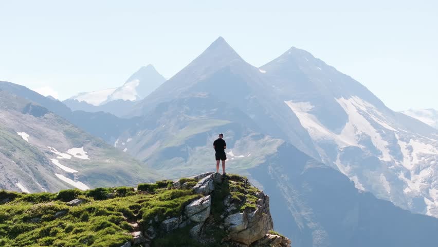Dramatic scenery unfolds as lone hiker overlooks Grossglockner High Alpine Road