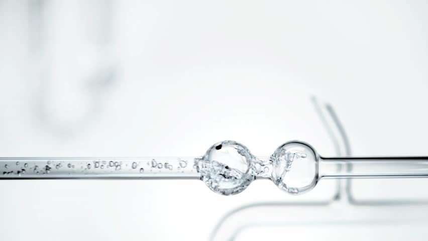 Glass test tubes with liquid on white background.