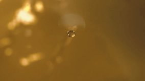 Shot of Swirling Oil Liquid, Pouring and Slashing Oil in slow motion. Slow Motion Shot of Waving Golden Liquid. - Powered by Shutterstock - Get 15% off with code: PIKWIZARD15