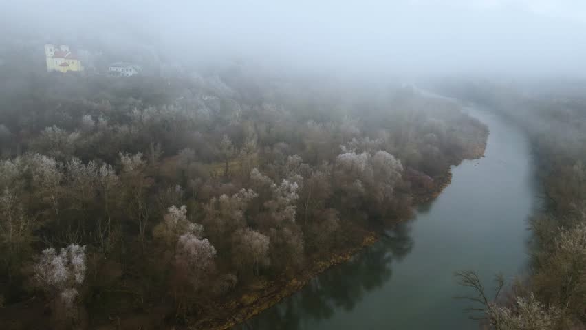 Church in nature under fog, river in fog, Slovakia, Sklaka nad Váhom
