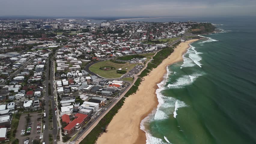 Aerial pulls out from Mereweather Beach at Newcastle, NSW, Australia