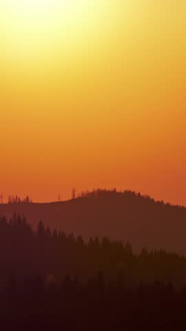 Big sun close-up, sunset behind the mountains Beautiful nature video time lapse landscape.Vertical