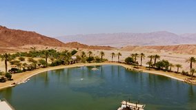 Aerial view of a stunning desert oasis, with turquoise waters contrasting golden sand dunes in Israel. - Powered by Shutterstock - Get 15% off with code: PIKWIZARD15