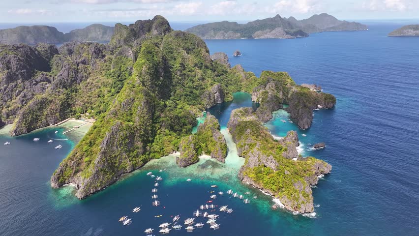 Breathtaking aerial of picturesque island in El Nido, Philippines. Rocky cliffs and colourful lagoons.
