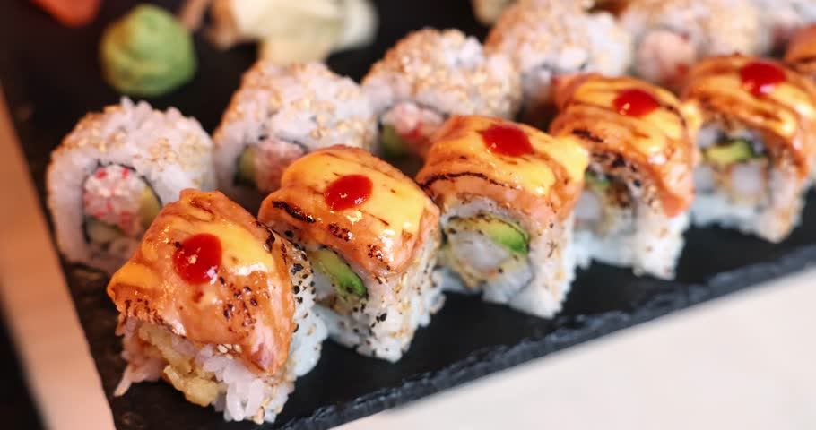 Delicious sushi rolls with spicy sauce and fresh ingredients at a local Asian restaurant