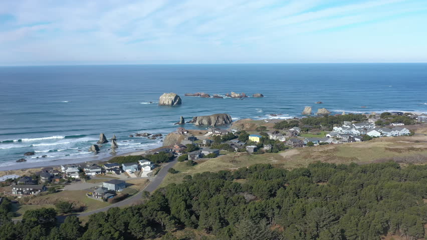 Sea stacks and homes in Bandon Beach, Southern Oregon. Drone backwards.