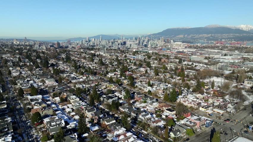 Distant View Of Downtown Vancouver Skyline From Knight Street At 14th Avenue In Vancouver, BC, Canada. aerial pullback shot
