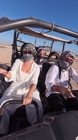 Egyptian activity with off-road vehicles and dust dirt road. Tourists driving on ATV, buggy, quads in the Sahara desert