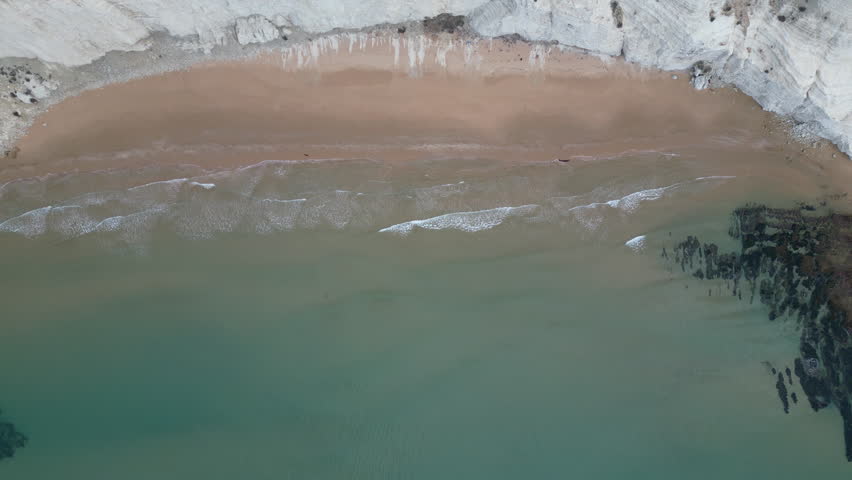 Aerial view of secluded beach in front of 