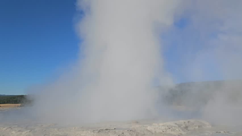 Water and steam is erupting from Geyser. Close up view.  Yellowstone National Park, Wyoming, United States