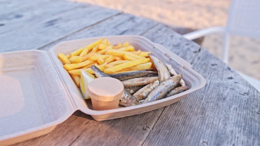Fried Fish and Chips French Fries Fast Food Snack in Styrofoam Box Sold at Seaside Beach Bar