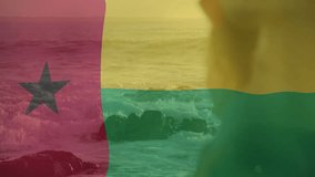 Animation of Guinea-Bissau flag overlaying ocean waves with person silhouette. Patriotism, tropical, national colors, freedom, identity, culture - Powered by Shutterstock - Get 15% off with code: PIKWIZARD15