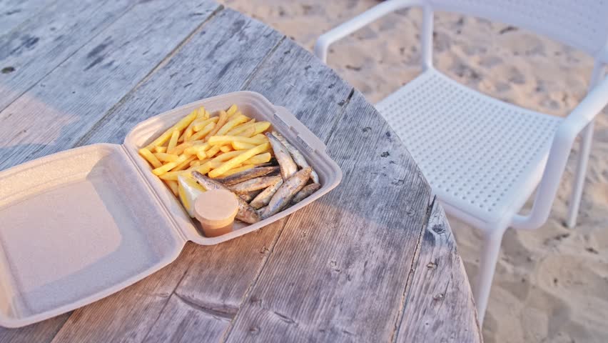 Fried Fish and Chips French Fries Fast Food Snack in Styrofoam Box Sold at Seaside Beach Bar