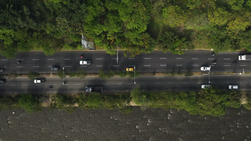 Top down drone shot of traffic on the Avenida regional, sunny day in Medellin