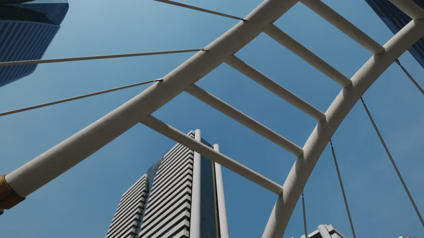 Chong Nonsi Skywalk - pedestrian walkway bridge arch and skyscrapers in the downtown Central Business District in Bangkok, Thailand, 4k