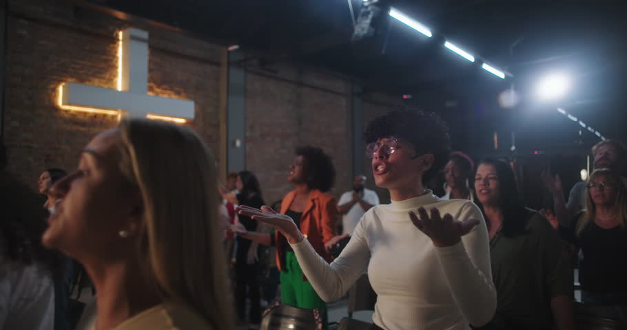 People raising hands in worship at church, emotional engagement, Christian spirituality praise Christian faith spiritual connection worship service