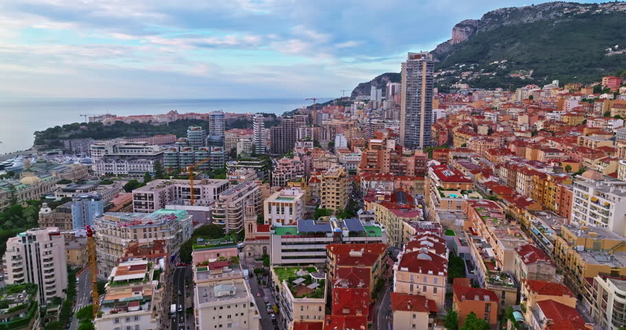 Birds eye aerial view of traffic in Monte Carlo, Monaco. Famous formula one Grand Prix Circuit. Aerial view of the city of Monaco. Establishing shot showcases luxury yachts moored in Monaco bay